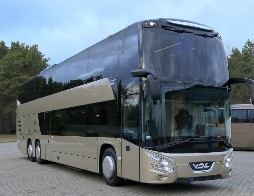 Modern coach rental Spain service parked near Madrid landmarks